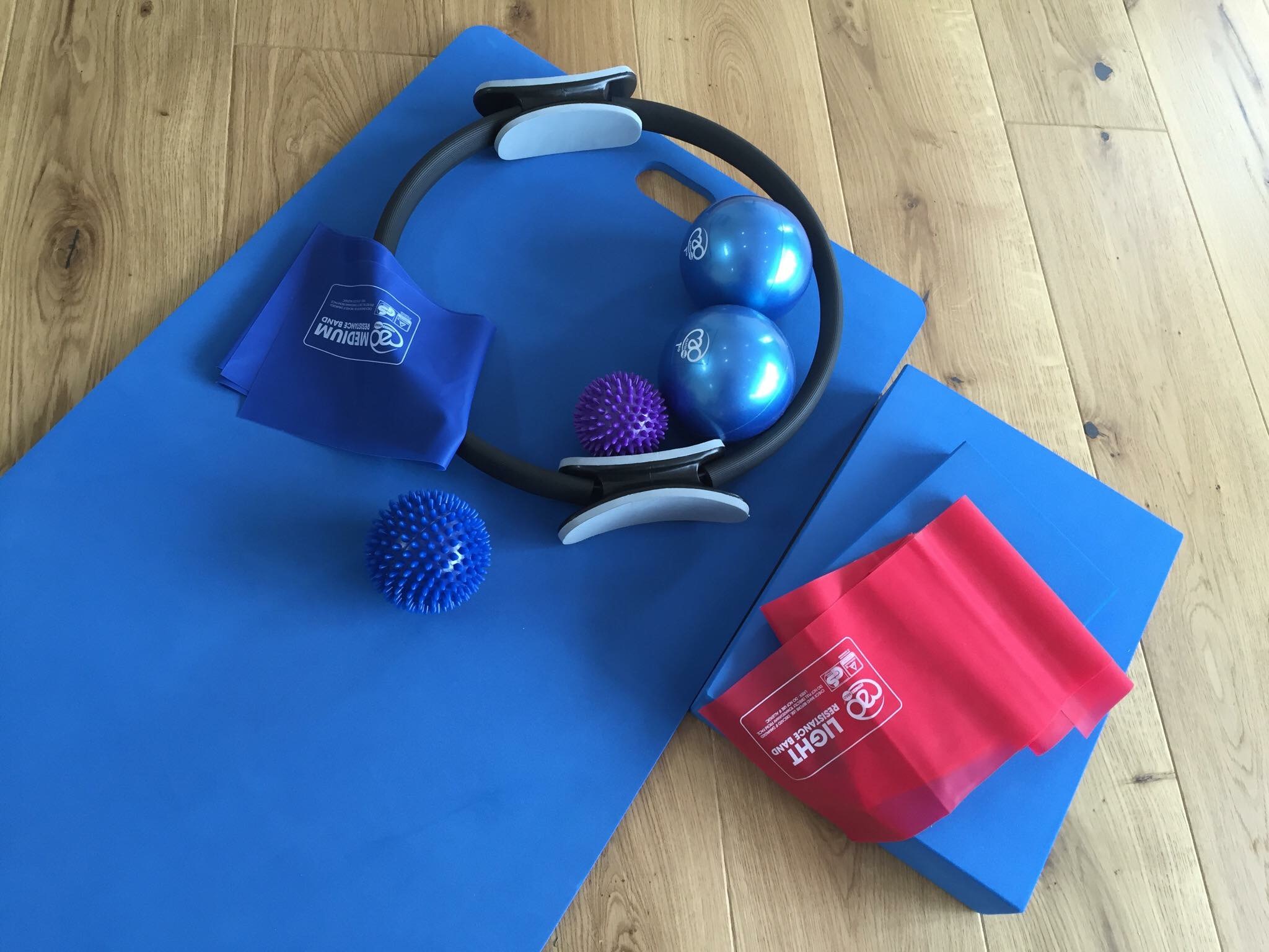 Pilates strength props — resistance bands, weighted balls, magic ring and massage balls
